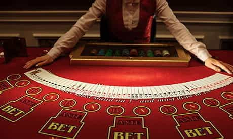 A Live Dealer Fanning out Cards on a Casino Table.