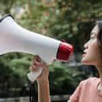 A woman speaking into a megaphone.